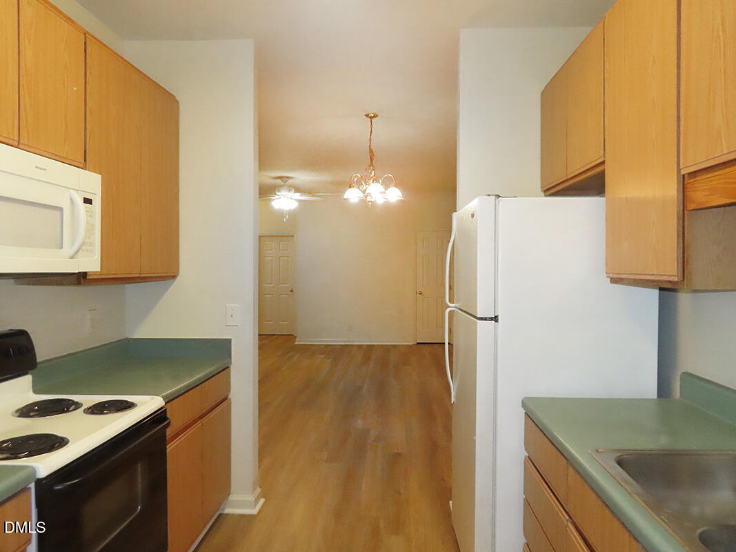 101 Rock Haven Road, Unit A100 Carrboro, NC 27510 - Photo 6 of 16 a kitchen with a sink a refrigerator and a stove