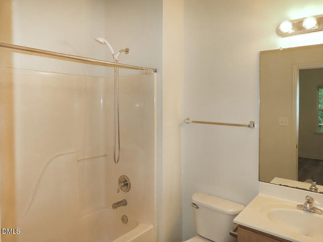 101 Rock Haven Road, Unit A100 Carrboro, NC 27510 - Photo 8 of 16 a bathroom with a bathtub shower sink vanity and toilet