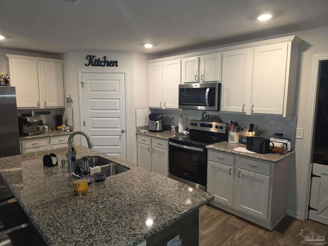 a kitchen with a sink stove and refrigerator