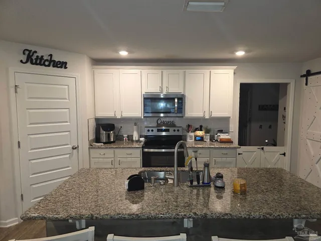 a view of a livingroom with wooden floor and closet