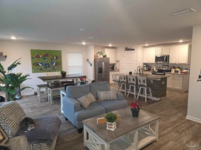 a kitchen with refrigerator and cabinets