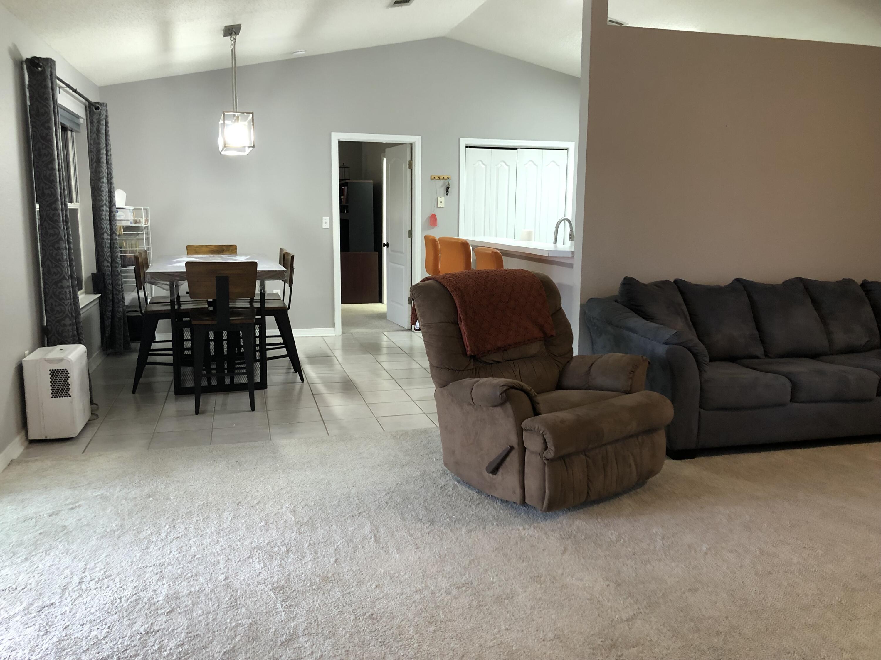 398 Riverchase Boulevard Crestview, FL 32536 - Photo 11 of 36 a living room with furniture and a dining table