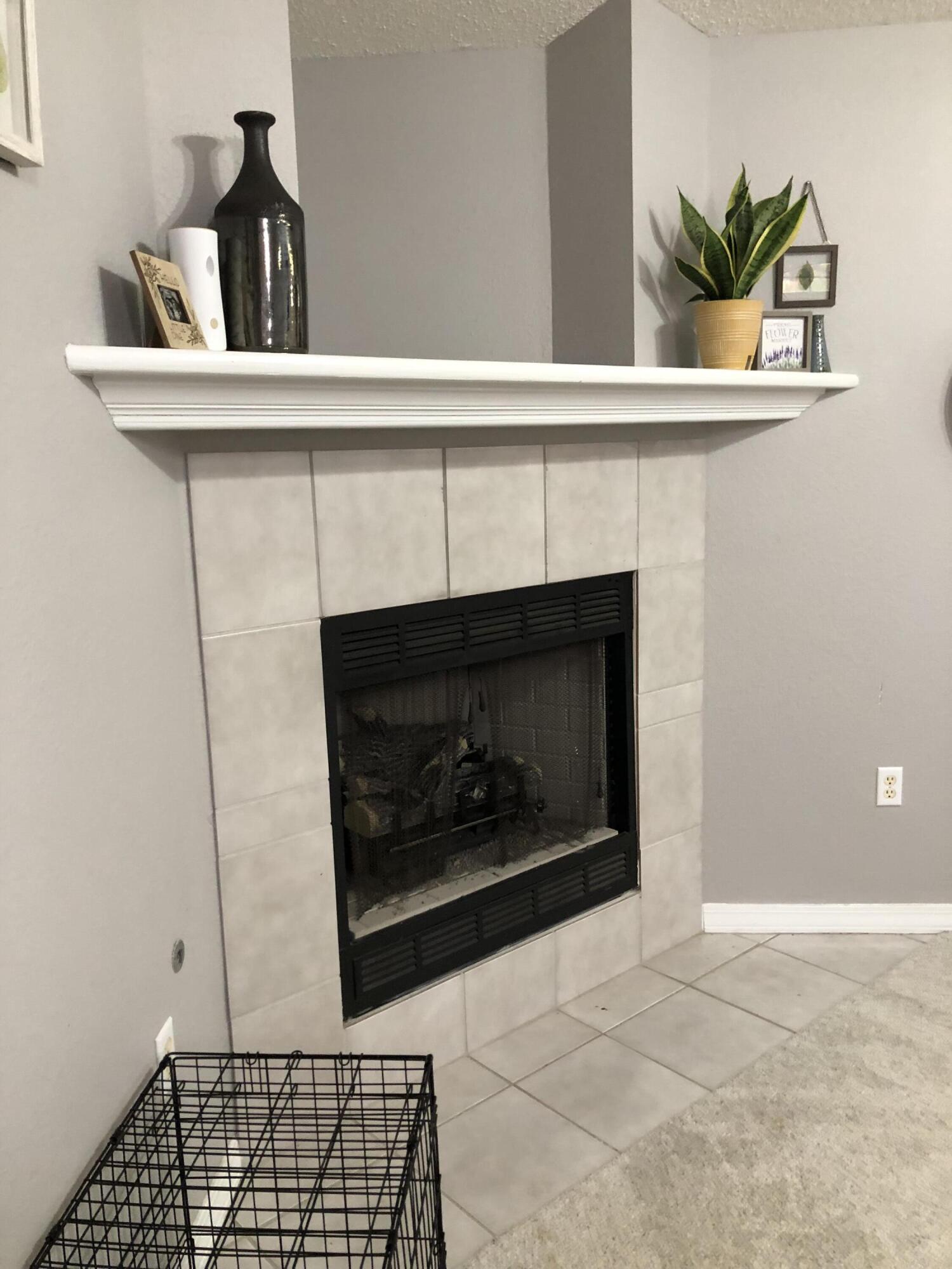 398 Riverchase Boulevard Crestview, FL 32536 - Photo 12 of 36 a living room with a fireplace and a potted plant
