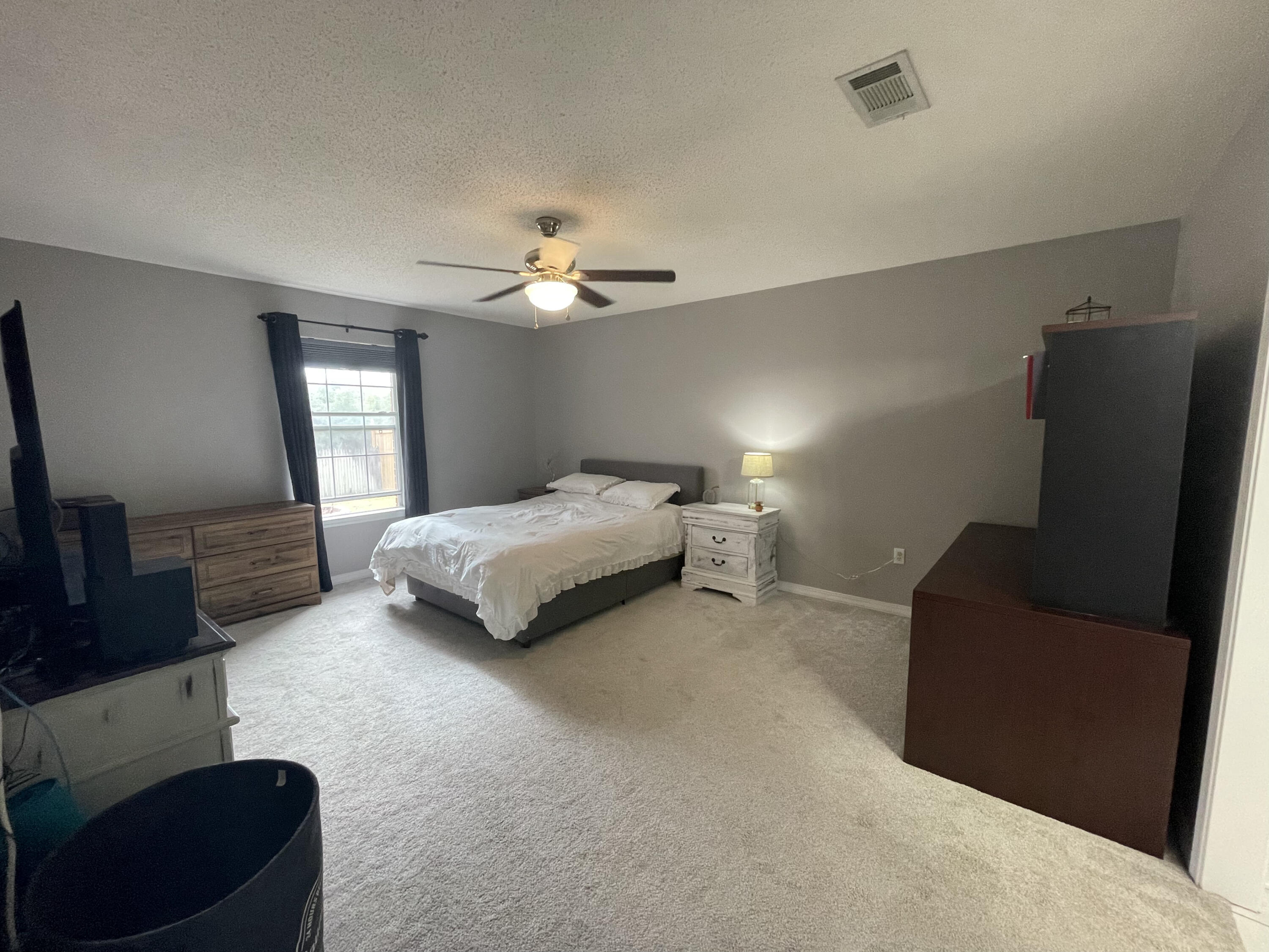 398 Riverchase Boulevard Crestview, FL 32536 - Photo 13 of 36 a spacious bedroom with a bed and a couch
