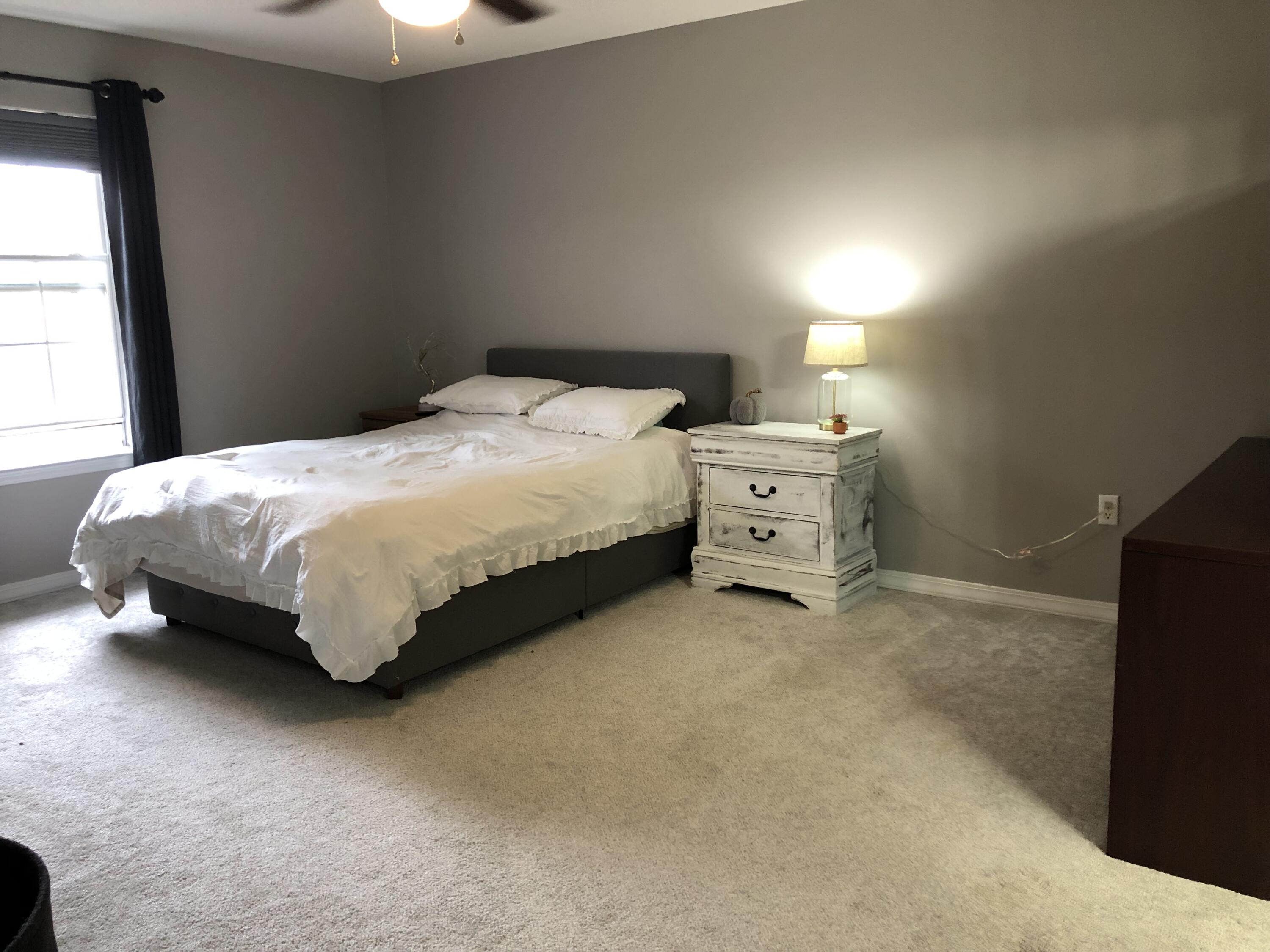 398 Riverchase Boulevard Crestview, FL 32536 - Photo 14 of 36 a bed sitting in a bedroom next to a window