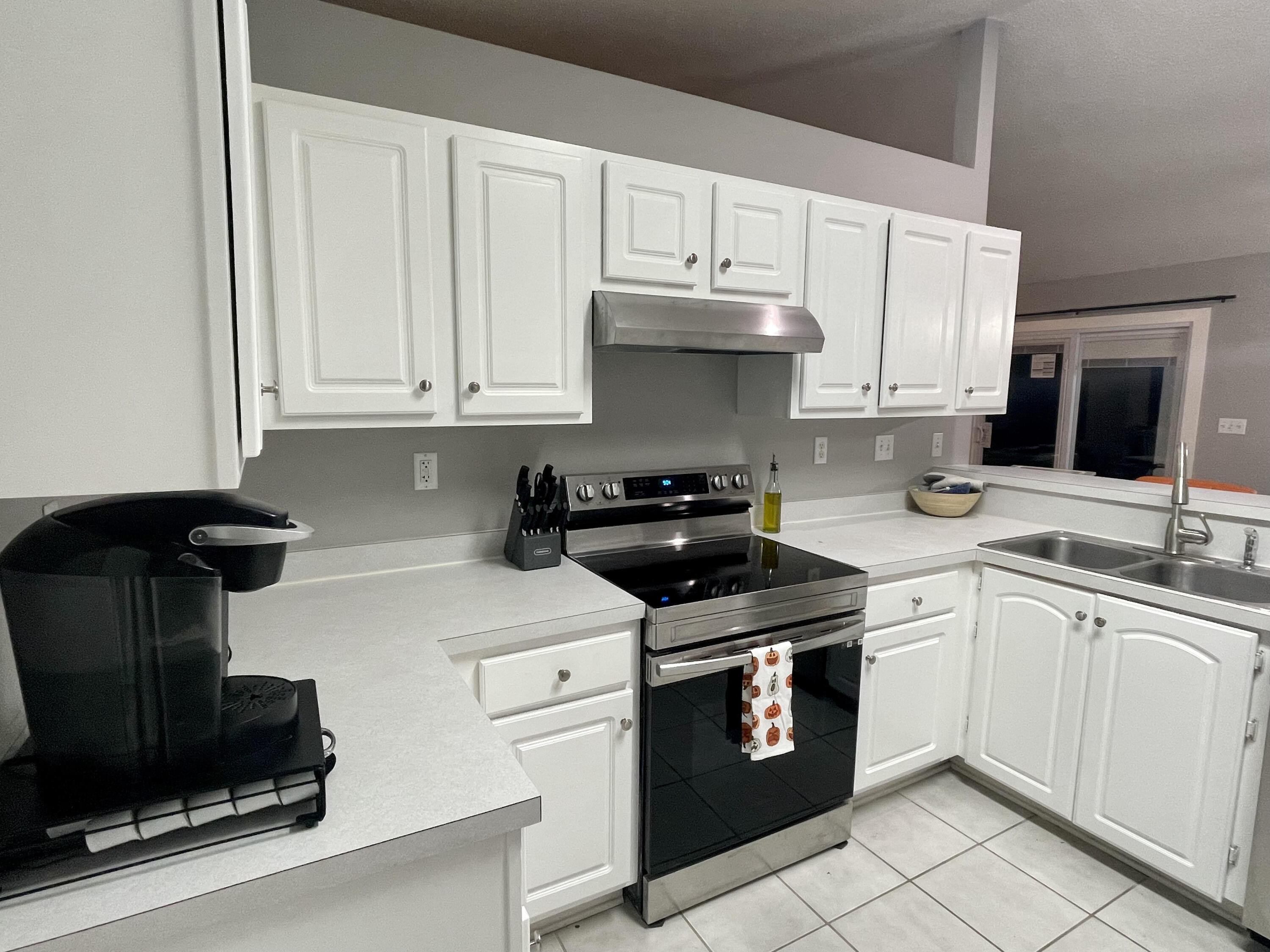 398 Riverchase Boulevard Crestview, FL 32536 - Photo 2 of 36 a kitchen with stainless steel appliances granite countertop a stove a sink and white cabinets