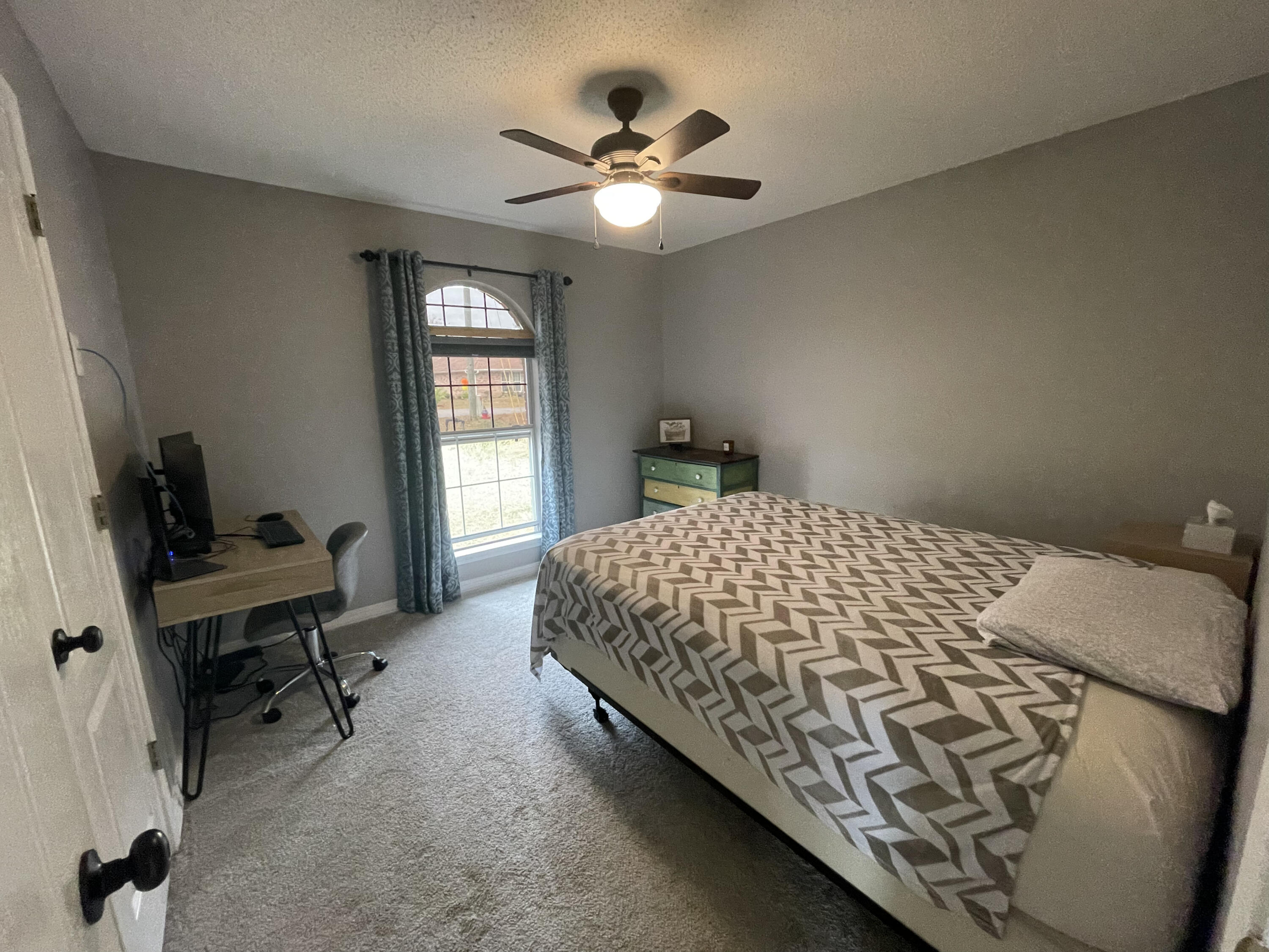 398 Riverchase Boulevard Crestview, FL 32536 - Photo 22 of 36 a bedroom with a bed and a chandelier
