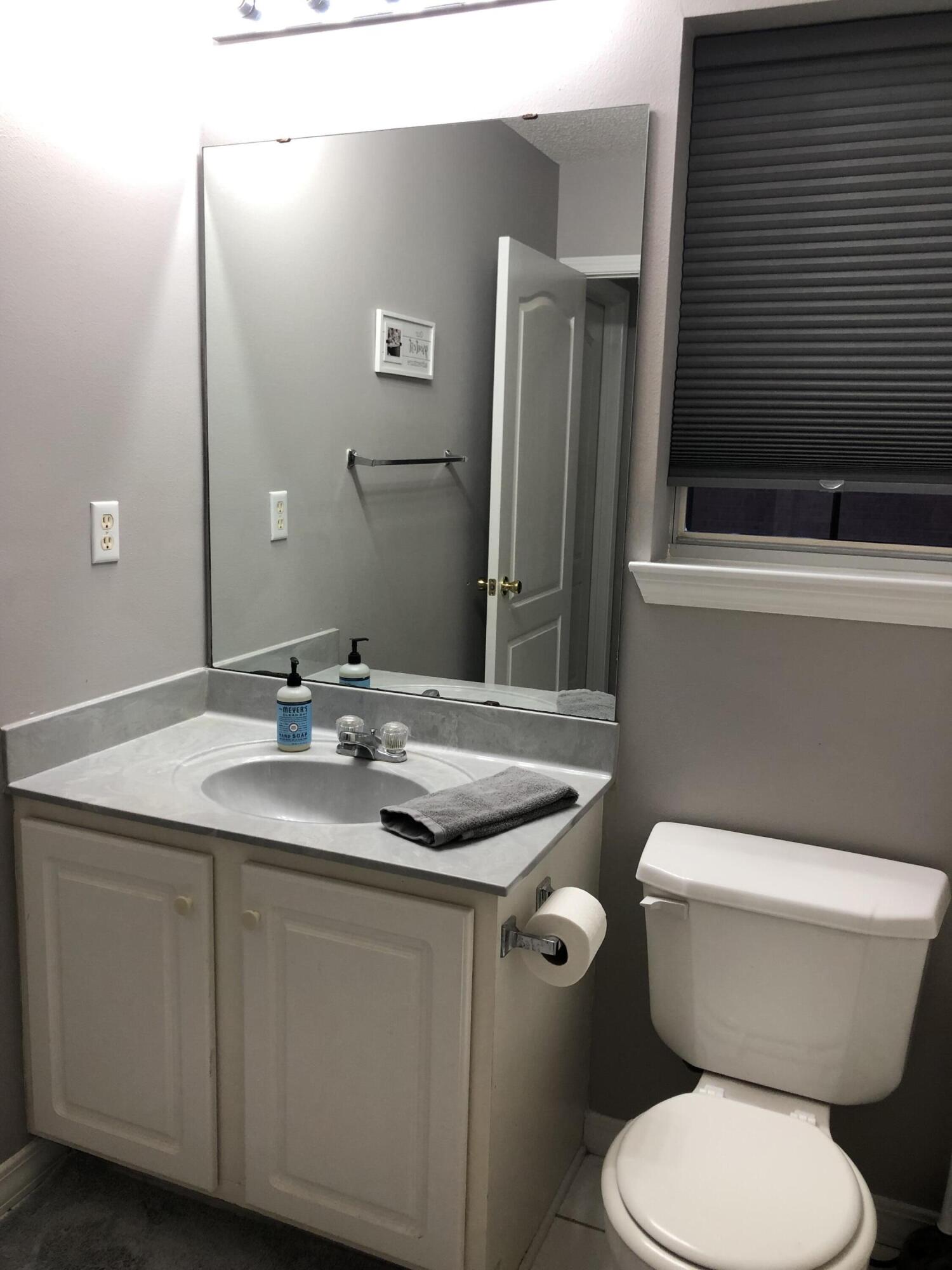 398 Riverchase Boulevard Crestview, FL 32536 - Photo 25 of 36 a bathroom with a toilet sink and mirror