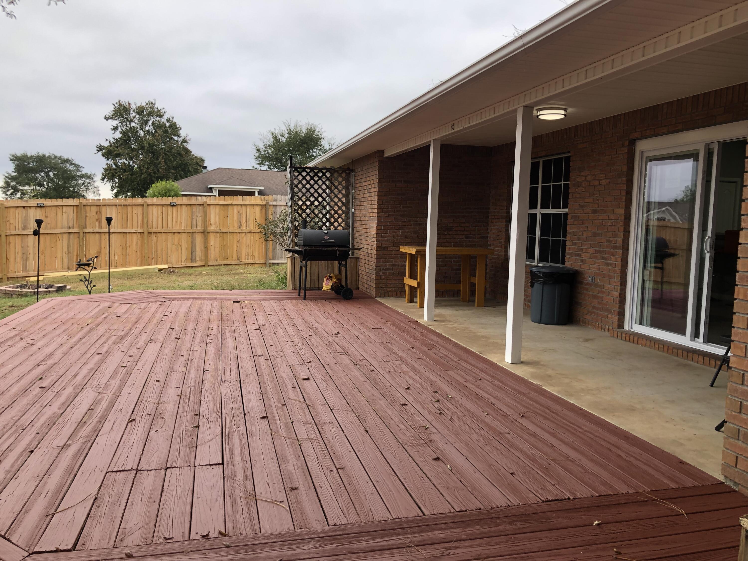 398 Riverchase Boulevard Crestview, FL 32536 - Photo 26 of 36 a view of backyard with wooden floor and fence and a ceiling fan