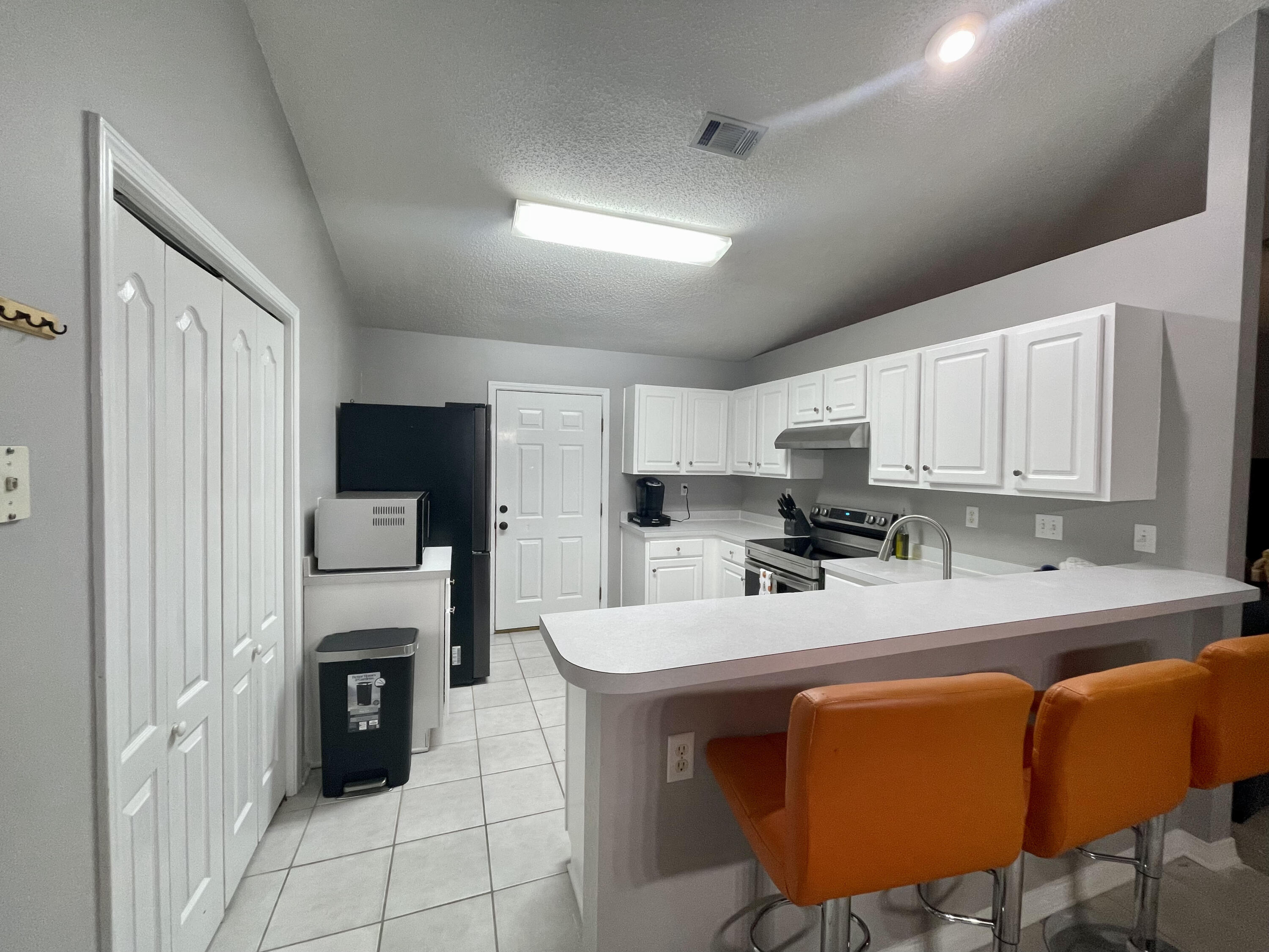 398 Riverchase Boulevard Crestview, FL 32536 - Photo 3 of 36 a kitchen with stainless steel appliances granite countertop a sink a stove a refrigerator cabinets and chairs