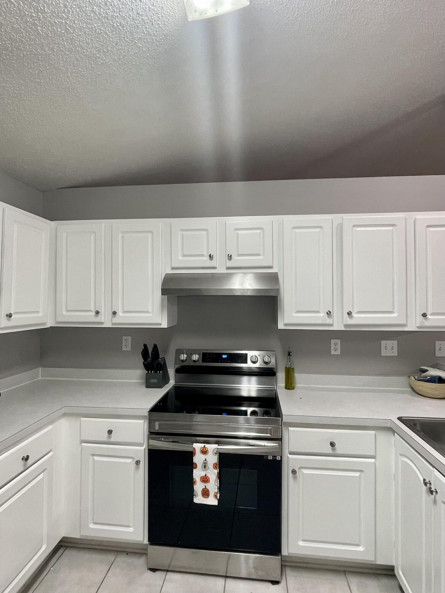 398 Riverchase Boulevard Crestview, FL 32536 - Photo 5 of 36 a kitchen with granite countertop white cabinets and stainless steel appliances