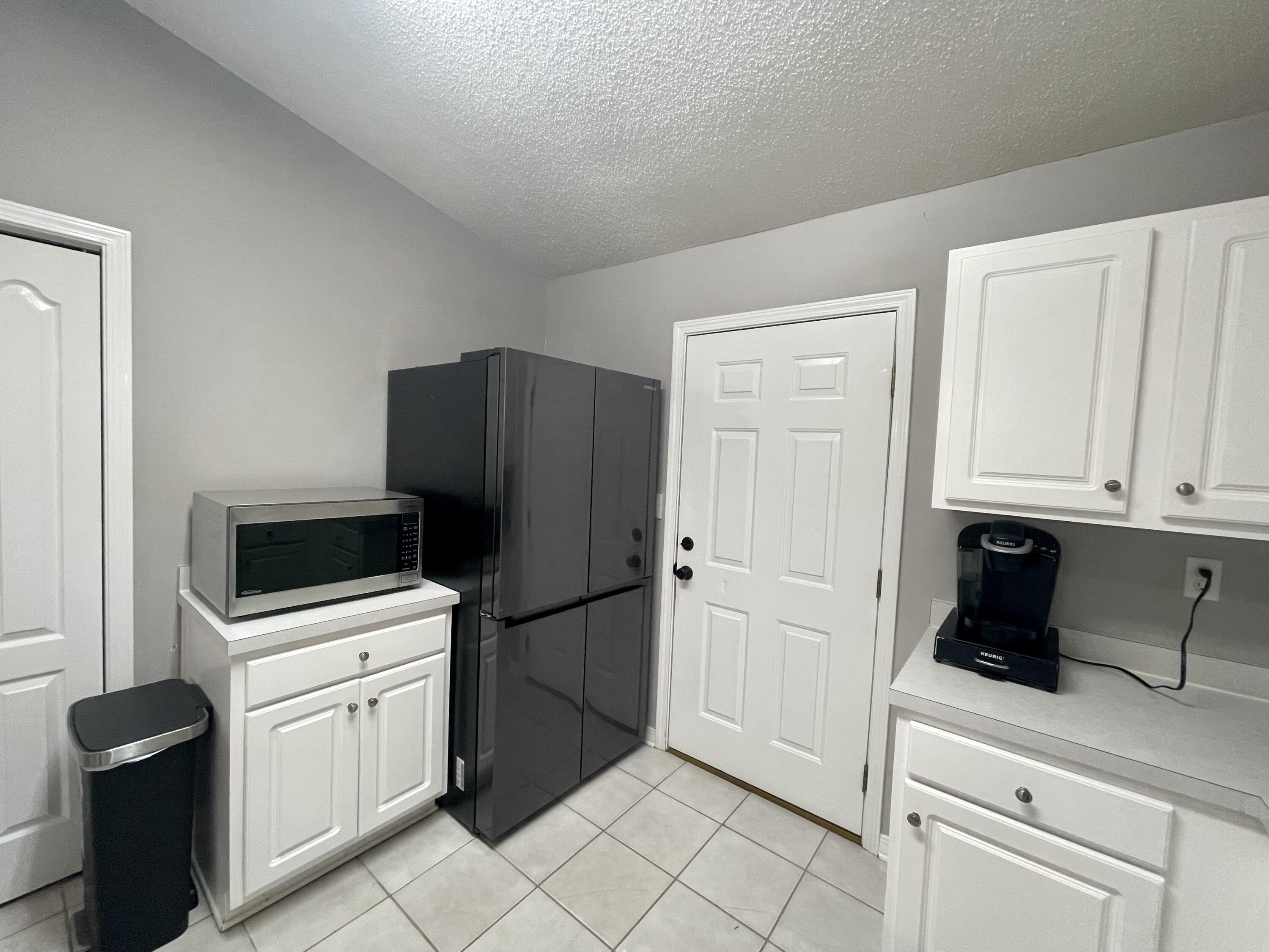 398 Riverchase Boulevard Crestview, FL 32536 - Photo 6 of 36 a kitchen with a refrigerator sink and cabinets