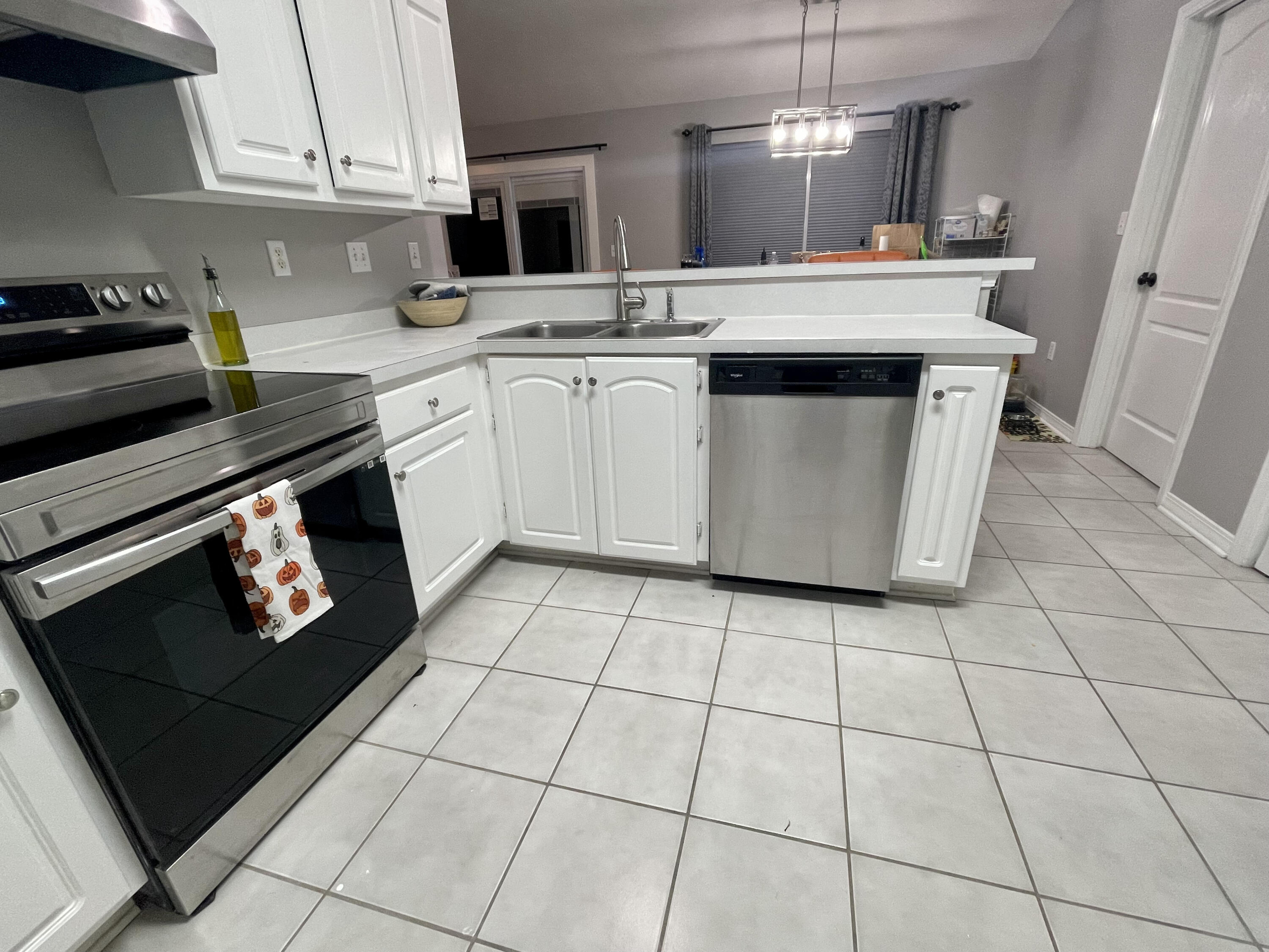 398 Riverchase Boulevard Crestview, FL 32536 - Photo 7 of 36 a kitchen with stainless steel appliances a stove a sink and a counter top space