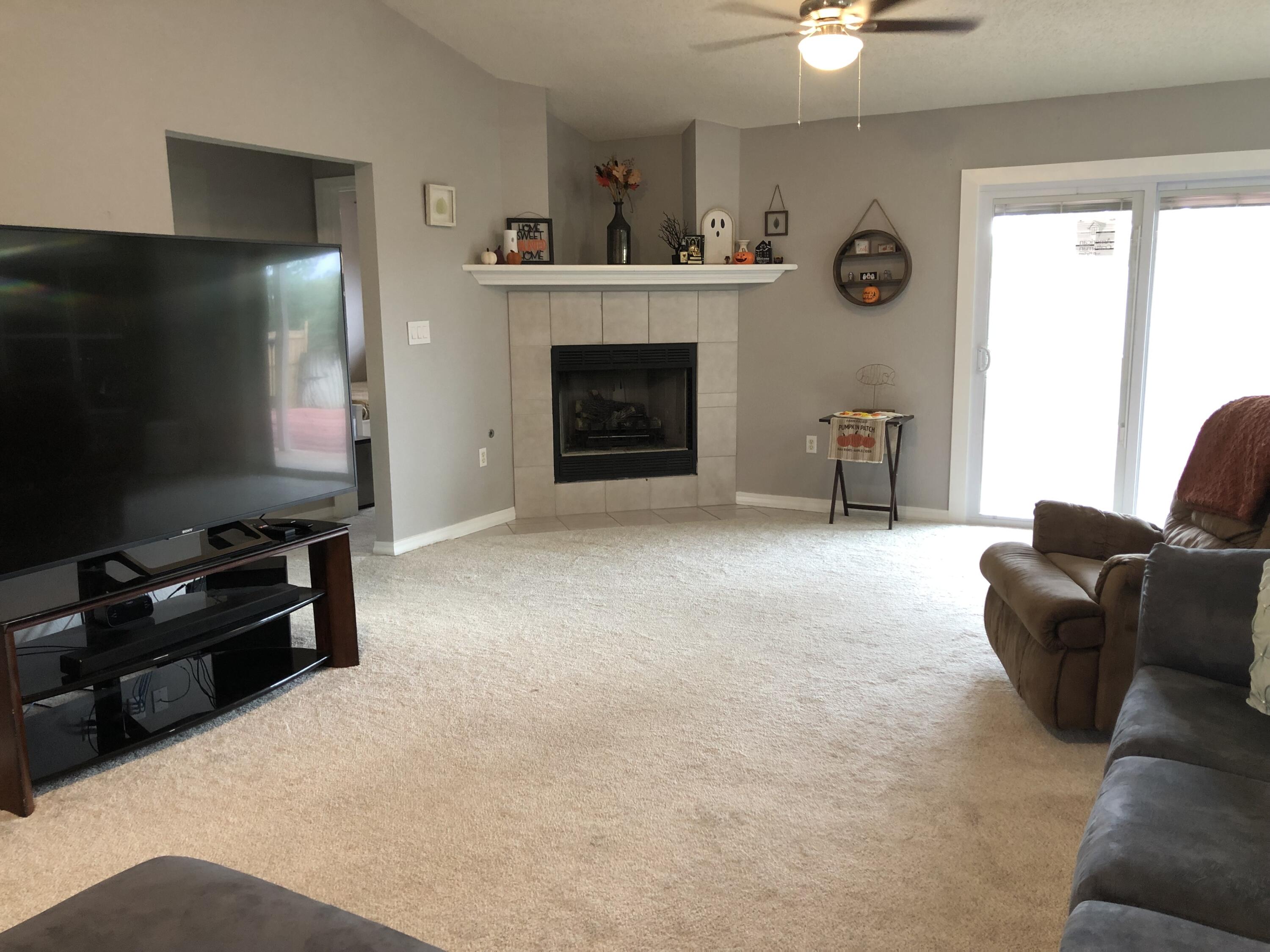 398 Riverchase Boulevard Crestview, FL 32536 - Photo 8 of 36 a living room with furniture and a flat screen tv