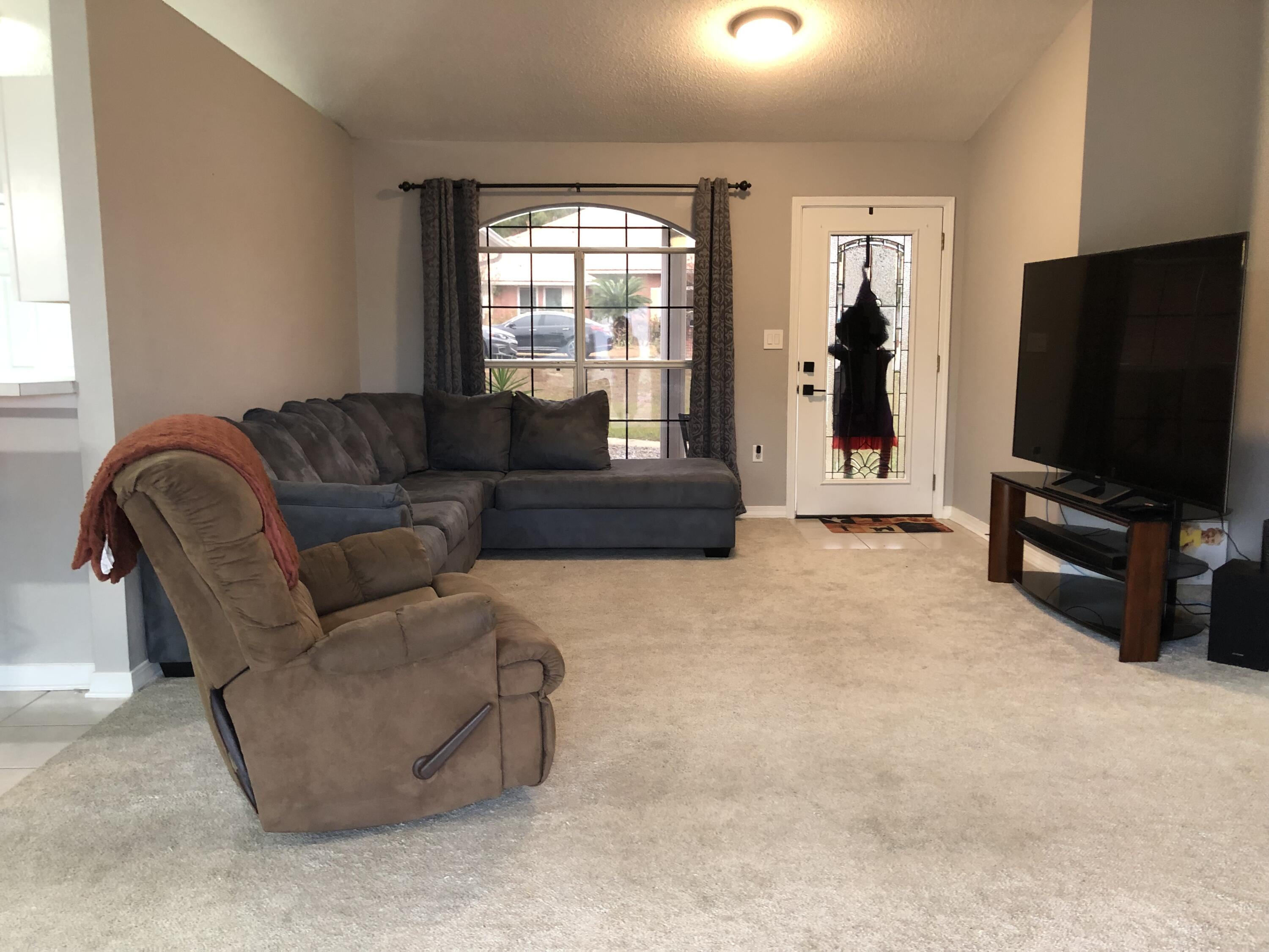398 Riverchase Boulevard Crestview, FL 32536 - Photo 9 of 36 a living room with furniture and a flat screen tv