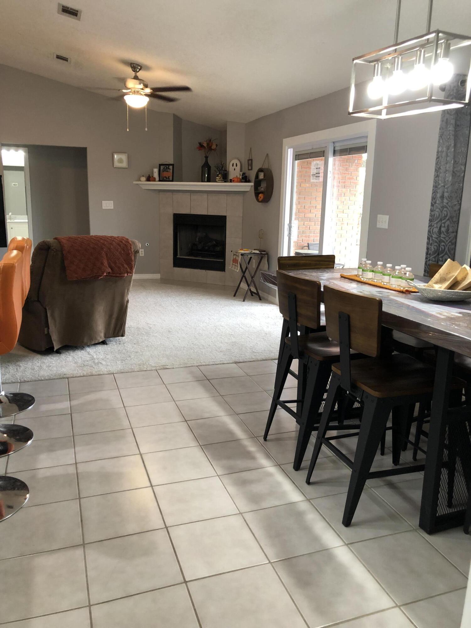 398 Riverchase Boulevard Crestview, FL 32536 - Photo 10 of 36 a living room with furniture a fireplace and a chandelier
