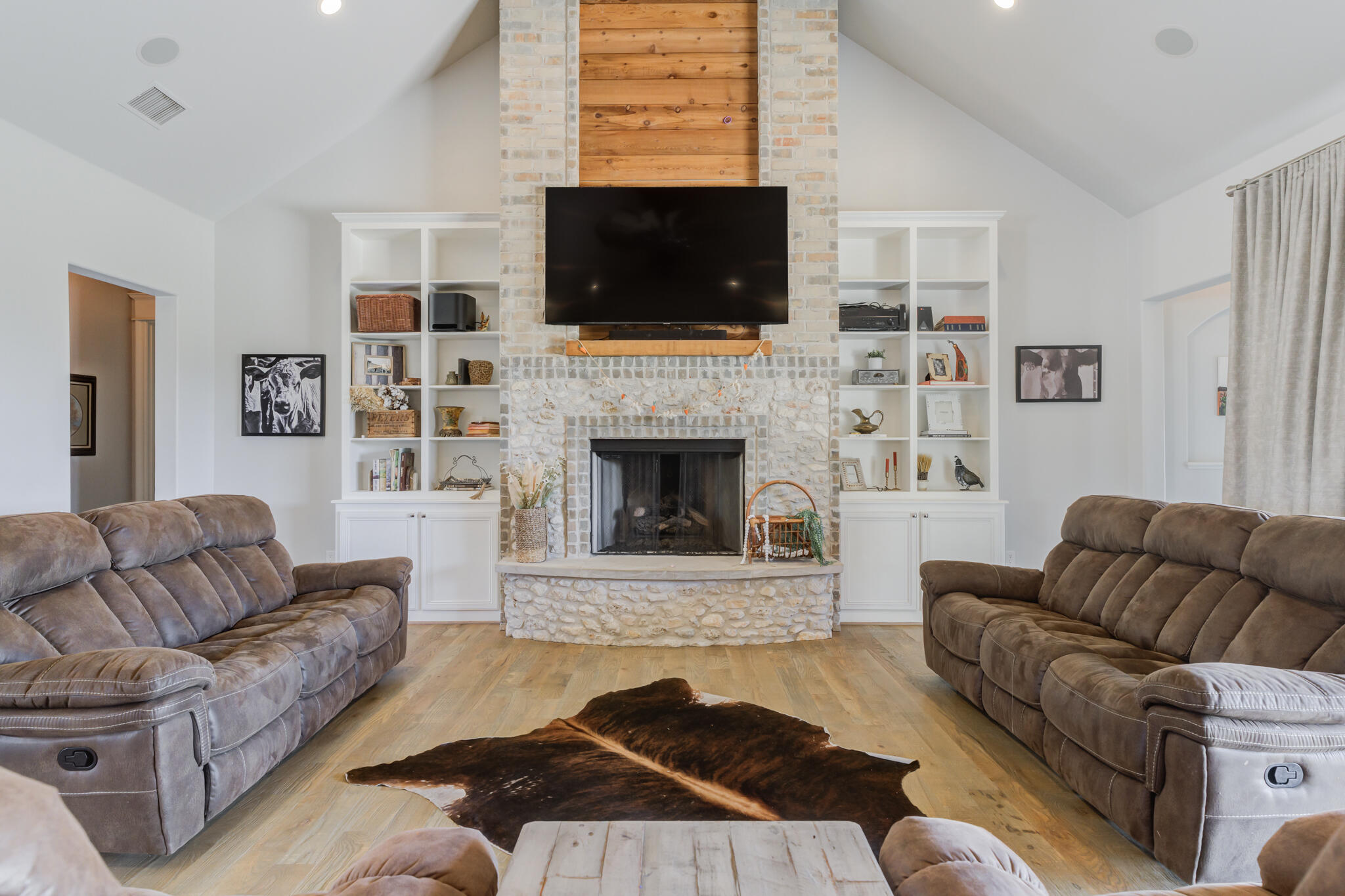 8917 County Road 6870 Lubbock, TX 79407 - Photo 14 of 53 a living room with furniture flat screen tv and a fireplace
