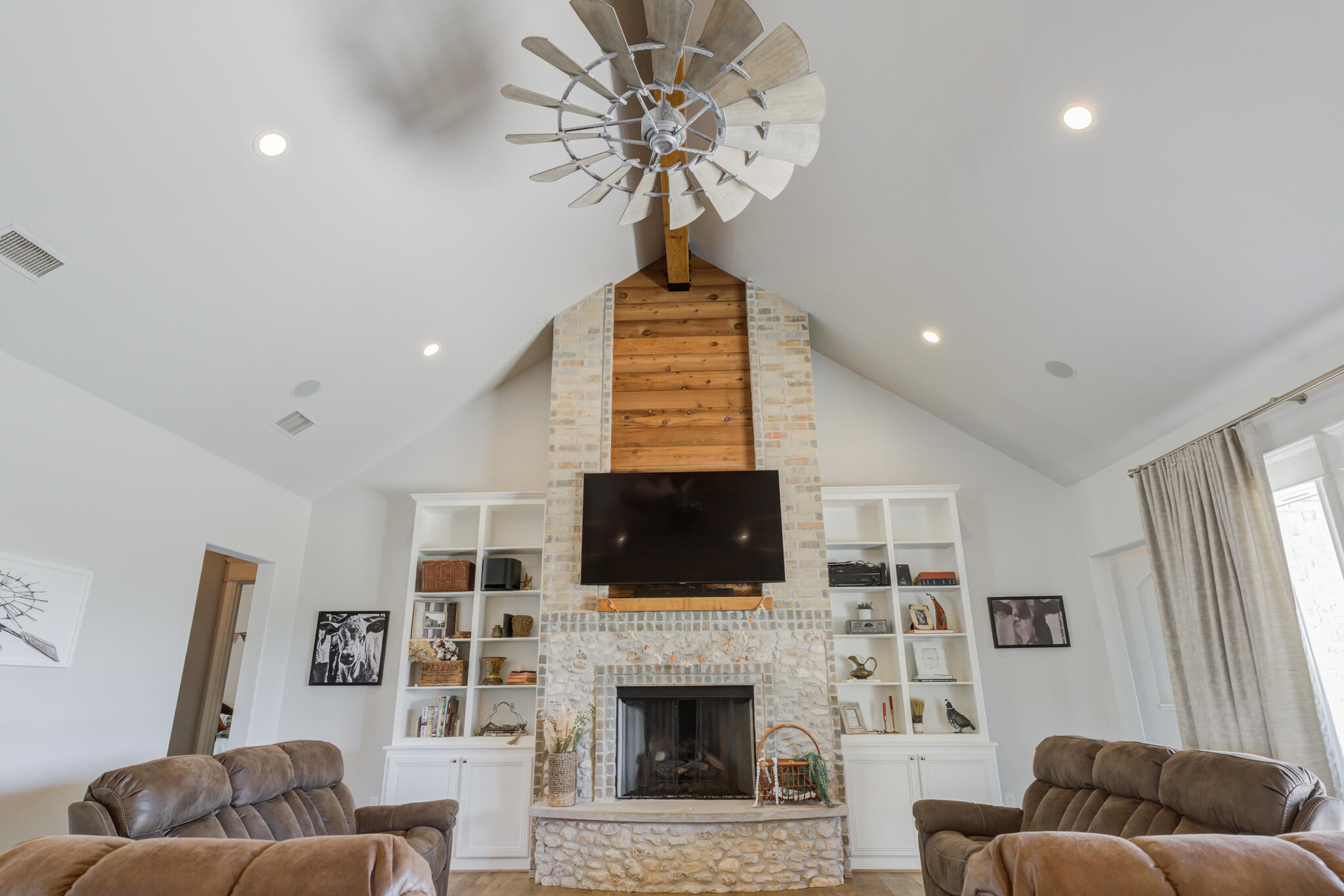 8917 County Road 6870 Lubbock, TX 79407 - Photo 15 of 53 a living room with furniture a flat screen tv and a fireplace