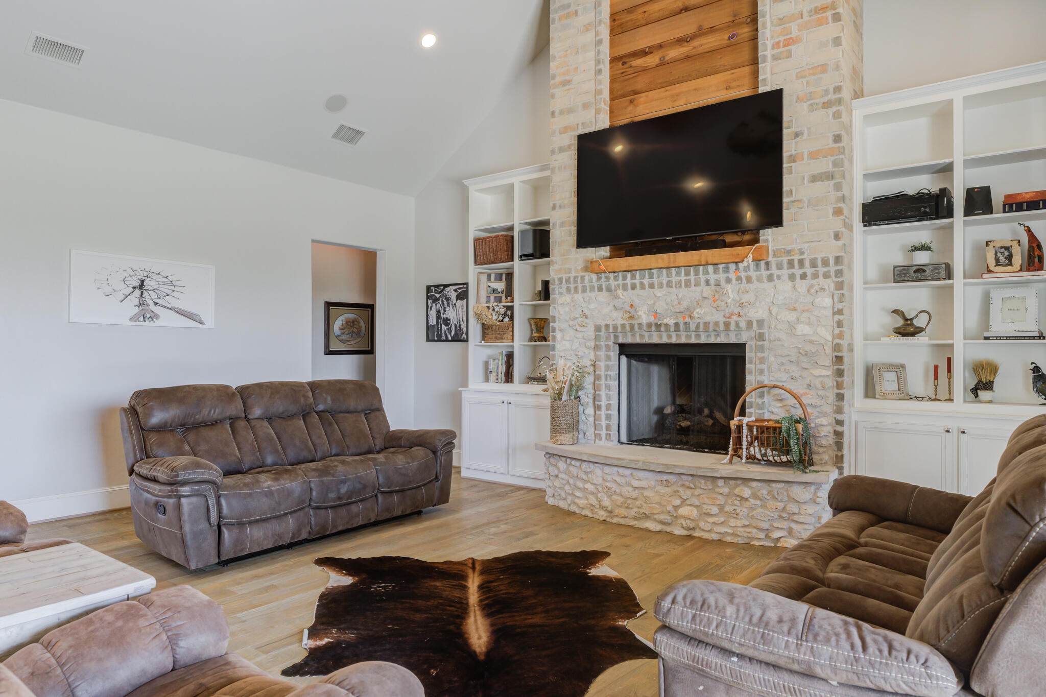 8917 County Road 6870 Lubbock, TX 79407 - Photo 16 of 53 a living room with furniture a flat screen tv and a fireplace