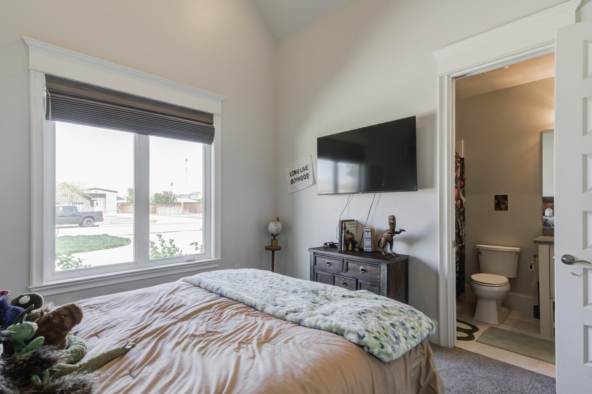 8917 County Road 6870 Lubbock, TX 79407 - Photo 33 of 53 a bedroom with a bed and a flat screen tv
