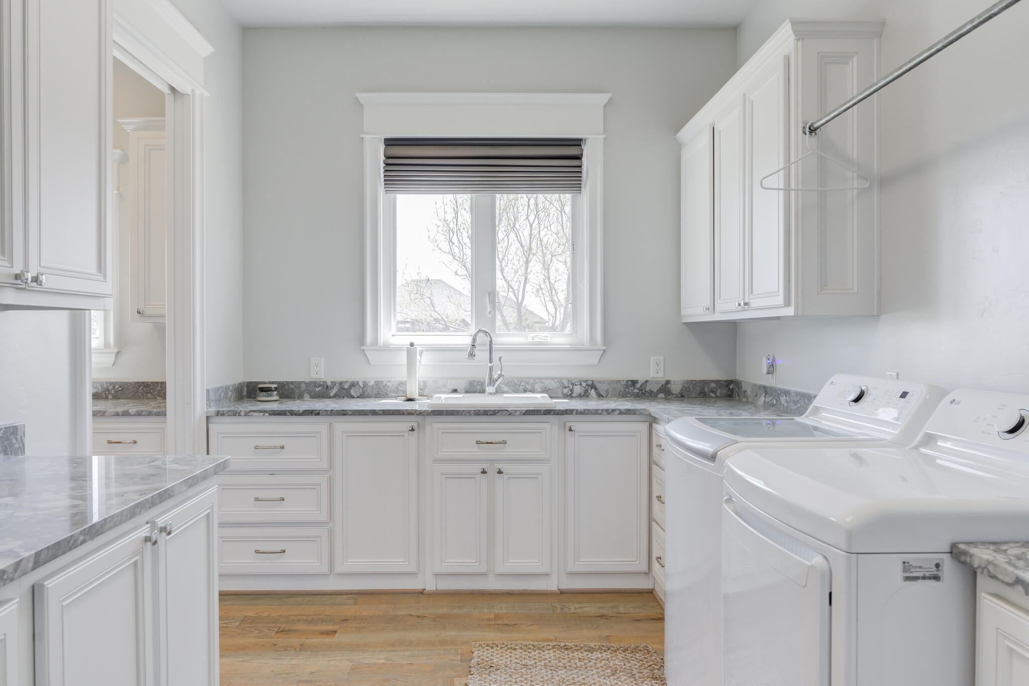 8917 County Road 6870 Lubbock, TX 79407 - Photo 39 of 53 a kitchen with granite countertop white cabinets and a window
