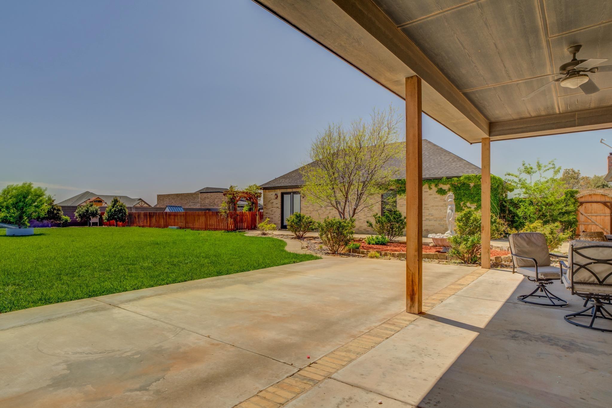 8917 County Road 6870 Lubbock, TX 79407 - Photo 41 of 53 a view of a patio with a table and chairs under an umbrella