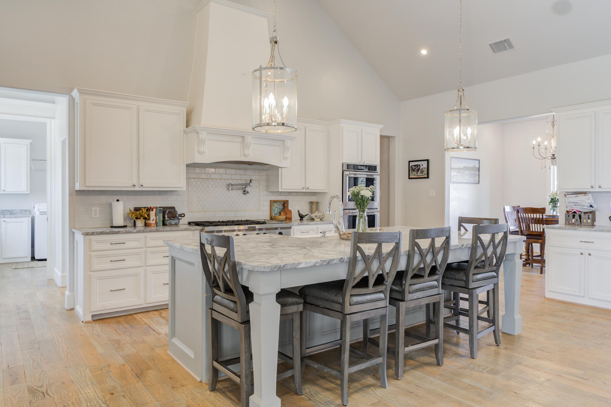 8917 County Road 6870 Lubbock, TX 79407 - Photo 5 of 53 a kitchen with kitchen island granite countertop a table chairs sink and cabinets