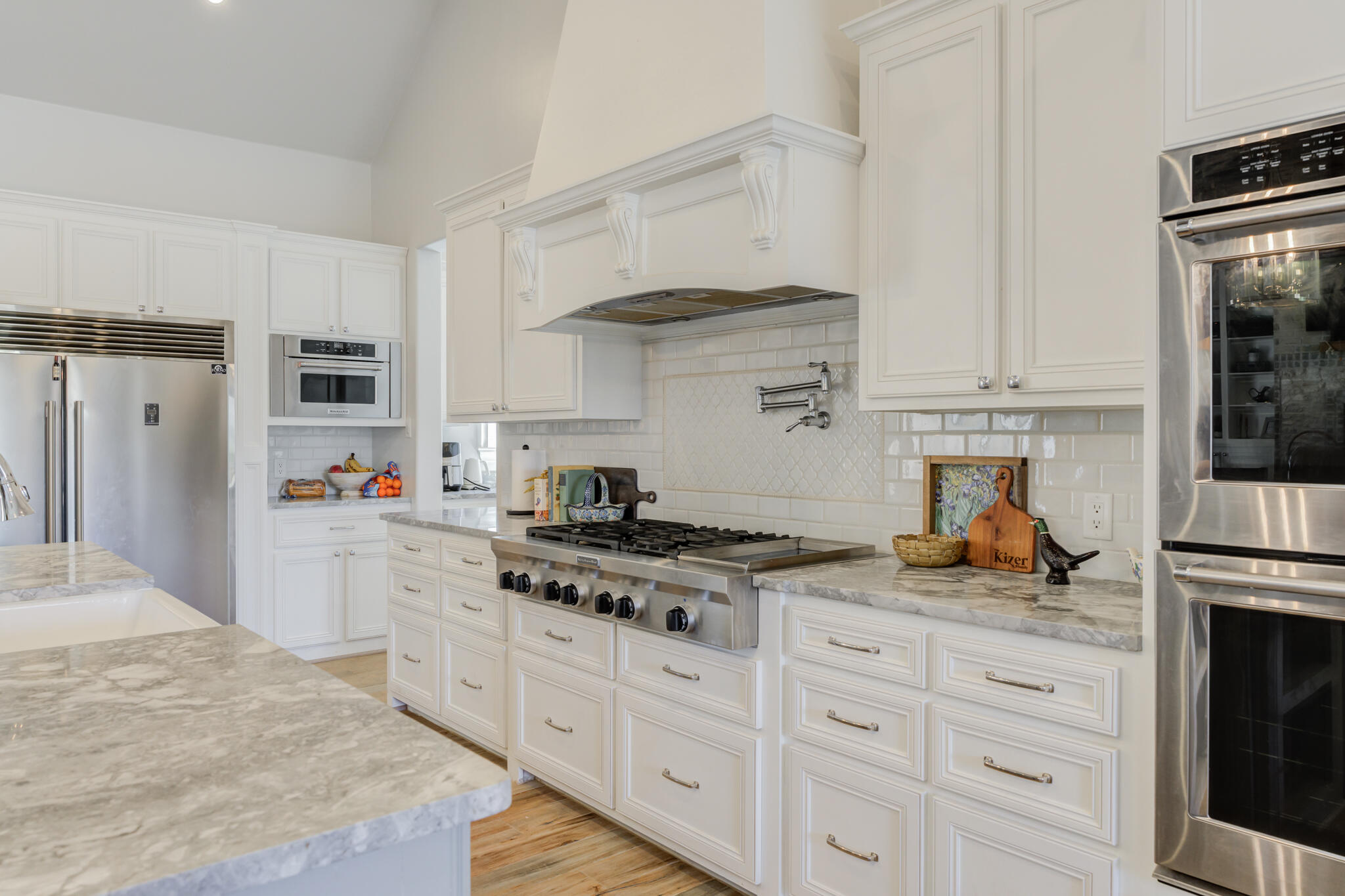 8917 County Road 6870 Lubbock, TX 79407 - Photo 8 of 53 a kitchen with granite countertop cabinets stainless steel appliances and wooden floor