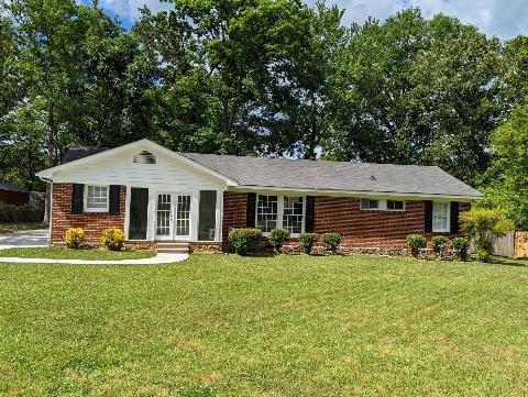 a front view of a house with yard patio and fire pit
