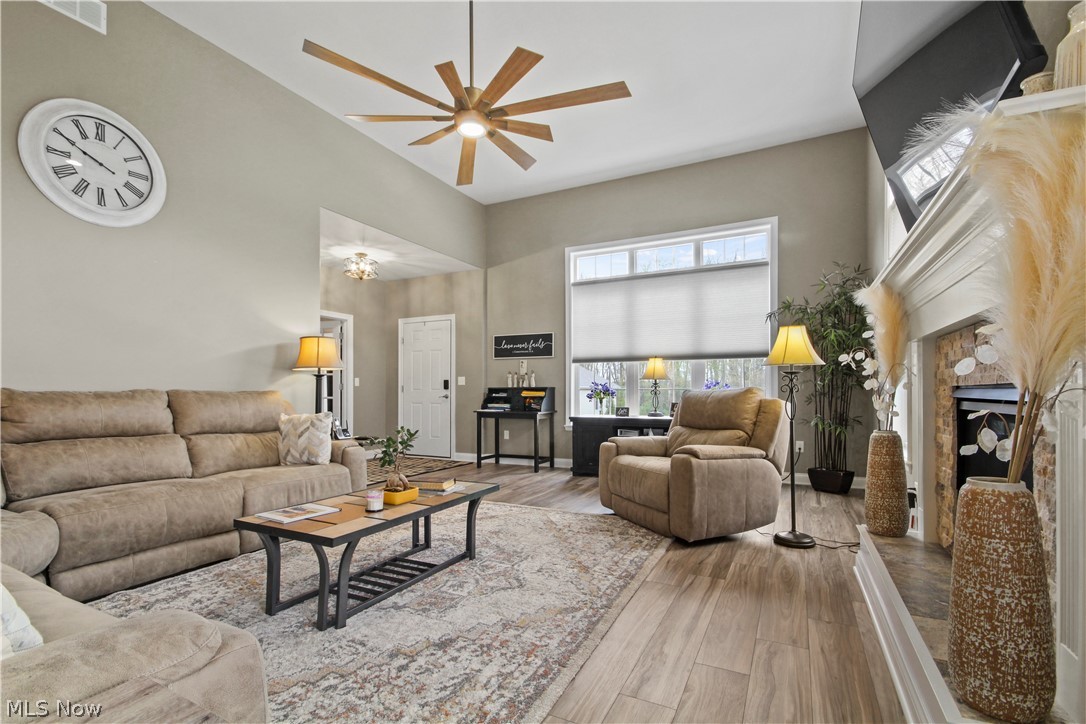 1805 East Western Reserve Road Youngstown, OH 44514 - Photo 20 of 31 Living room featuring hardwood / wood-style floors, ceiling fan, and a high ceiling