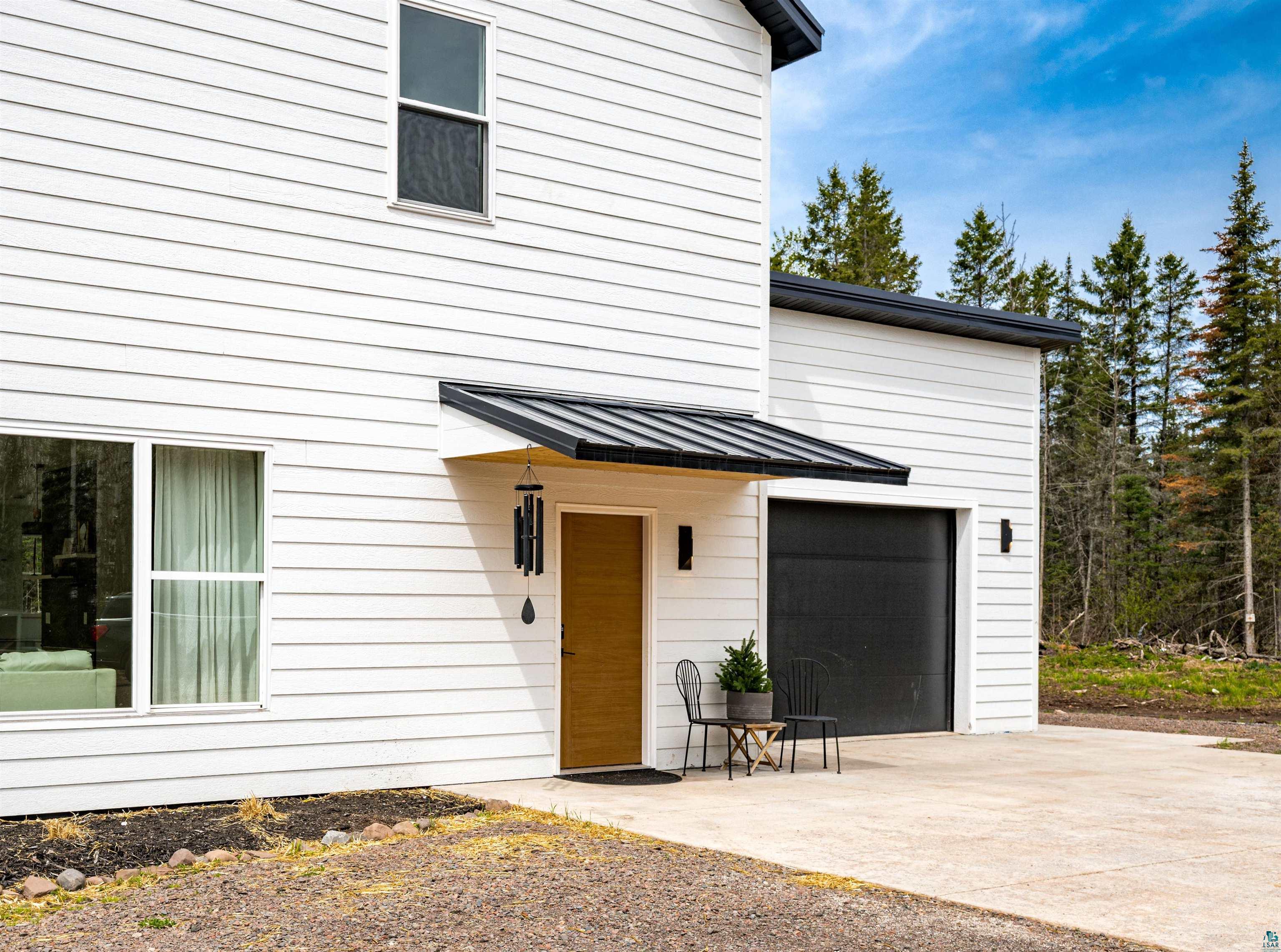 1825 East Shilhon Road Duluth, MN 55804 - Photo 6 of 37 Modern white LP siding exterior & metal roofs.