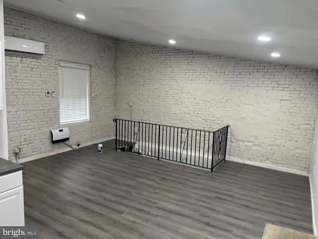 a view of a livingroom with wooden floor and chair