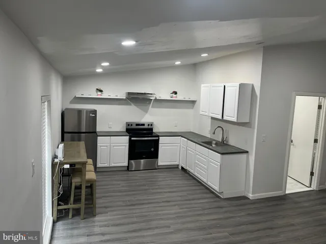 a kitchen with stainless steel appliances a refrigerator and a stove top oven