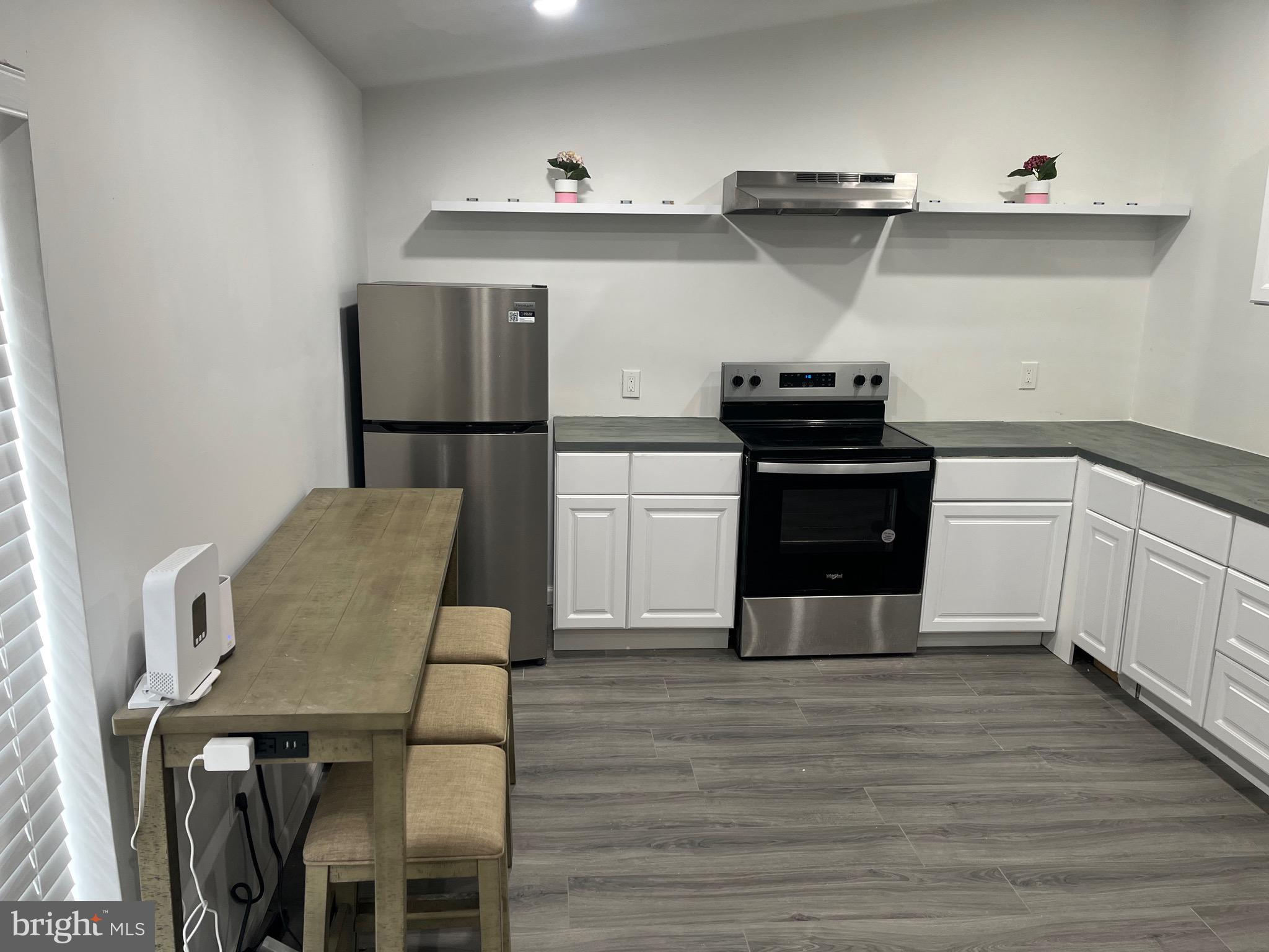 237 Jackson Street, Unit 4 Trenton, NJ 08611 - Photo 7 of 11 a kitchen with cabinets and wooden floor