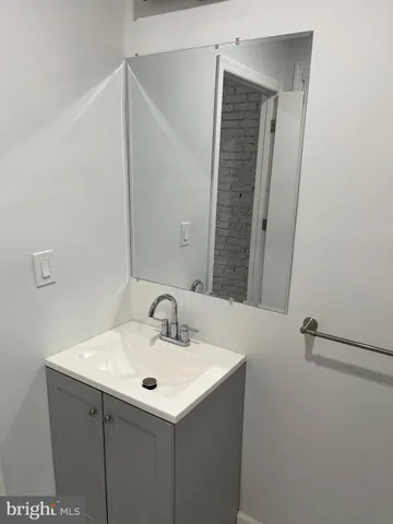 a bathroom with a sink and mirror