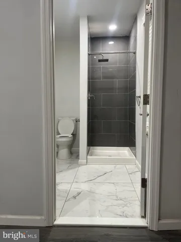 a bathroom with a glass shower door
