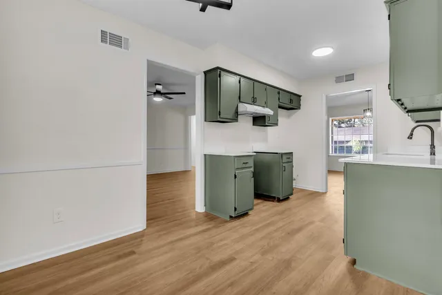 a kitchen with stainless steel appliances kitchen island a refrigerator sink and stove