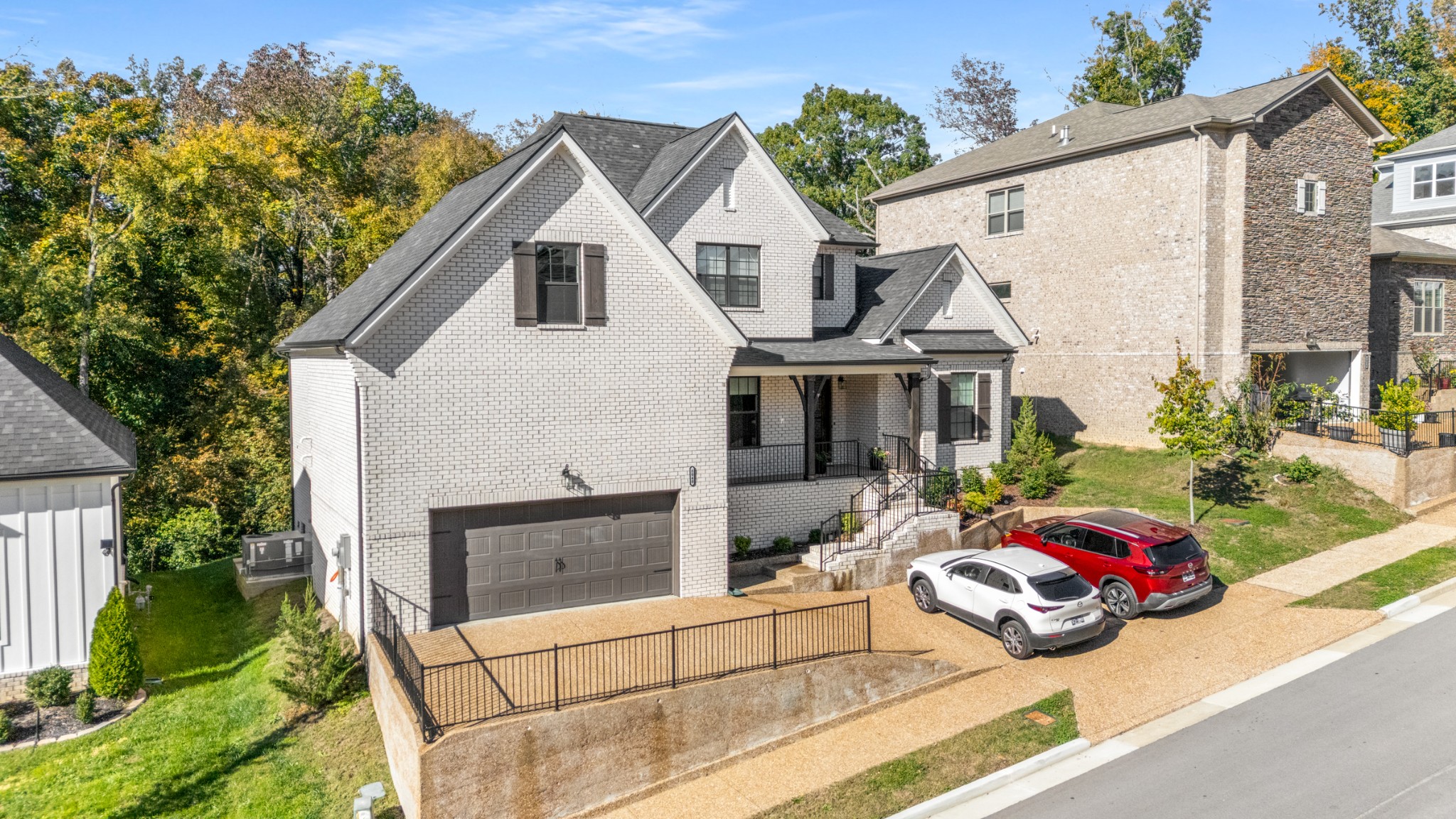 8040 Still Spg Rdg Drive Nashville, TN 37221 - Photo 38 of 38 a view of a white house with a yard and potted plants