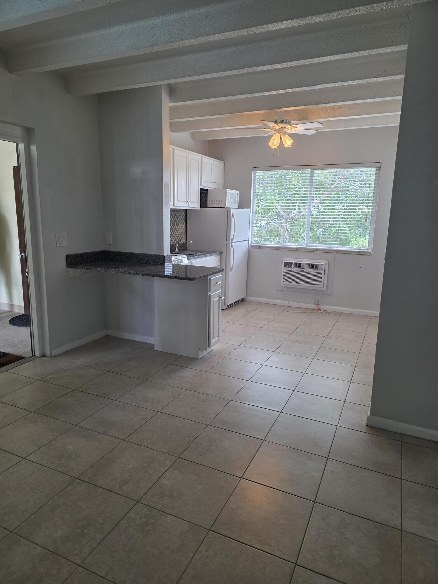 100 Cascade Lane, Unit 9 Palm Beach Shores, FL 33404 - Photo 3 of 7 a kitchen with a sink a counter top space and appliances
