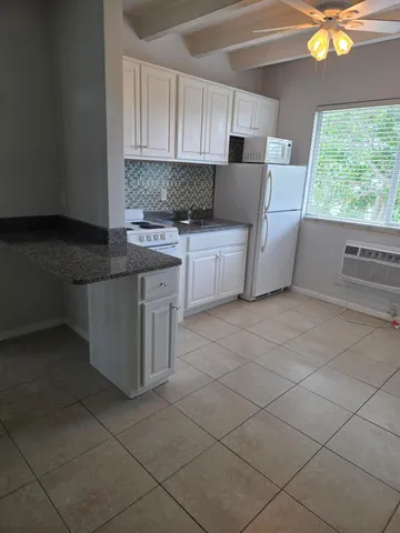 a kitchen with stainless steel appliances a sink stove and cabinets