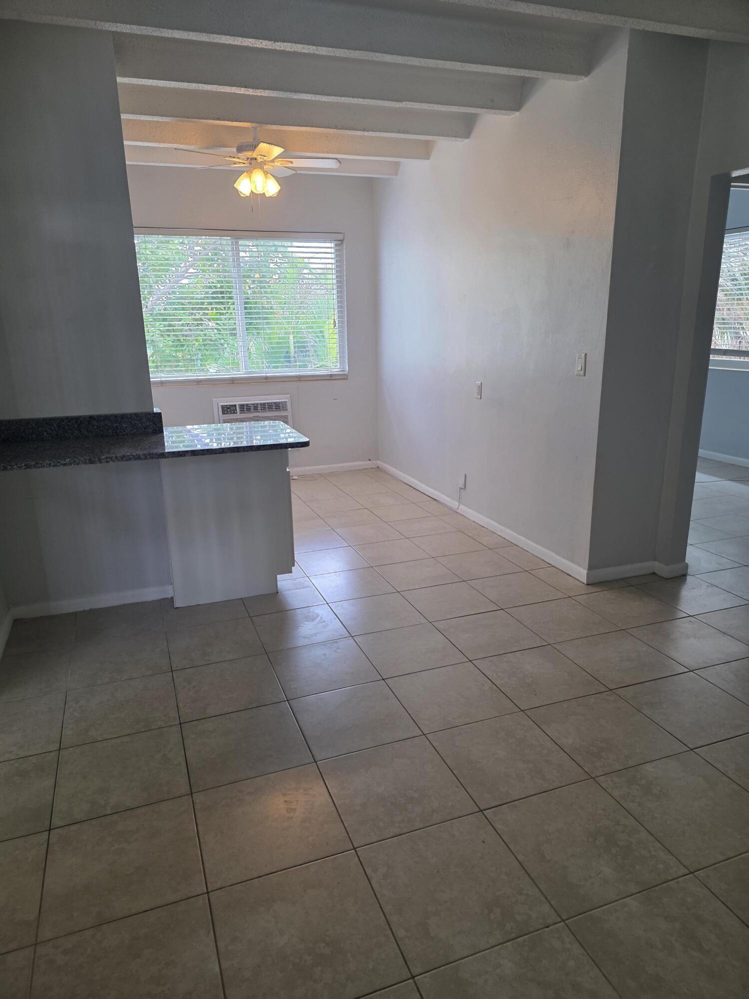 100 Cascade Lane, Unit 9 Palm Beach Shores, FL 33404 - Photo 5 of 7 a view of a kitchen with furniture and window