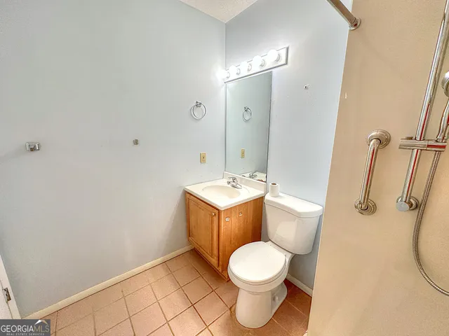 a bathroom with a toilet sink and a mirror