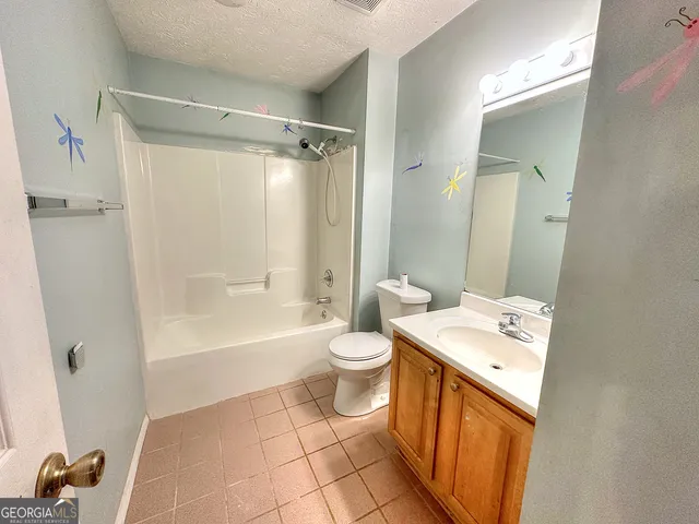 a bathroom with a sink a toilet and shower a mirror