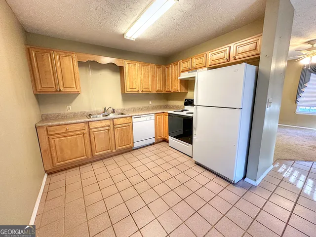 a kitchen with stainless steel appliances a refrigerator sink and cabinets
