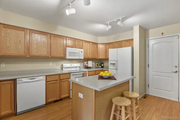 a kitchen with a sink a stove a refrigerator and cabinets