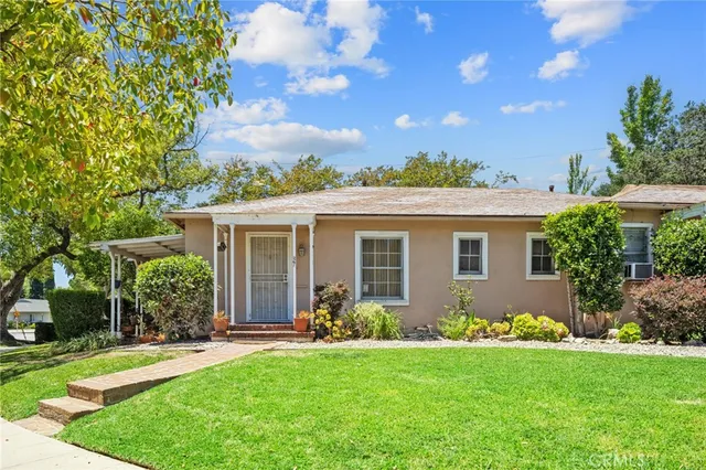 a front view of house with yard and green space