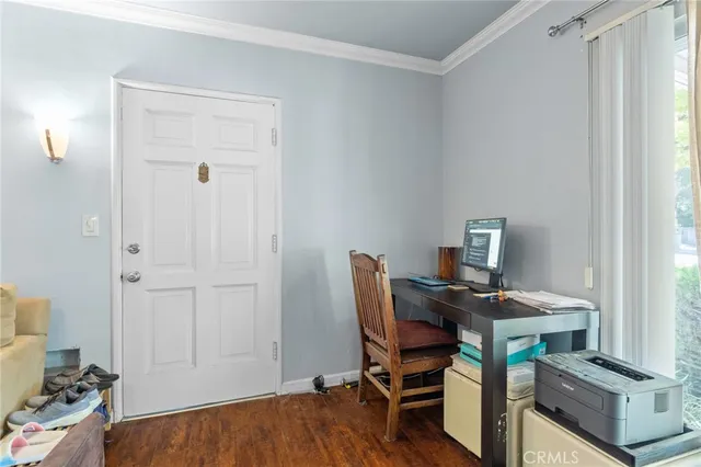 a view of a workspace with furniture and a window
