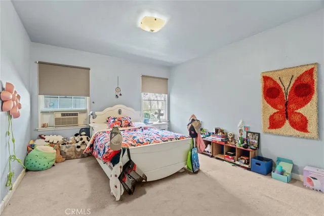 a bedroom with bed and a window