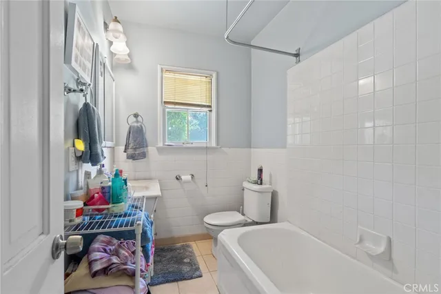 a bathroom with a bathtub sink and mirror