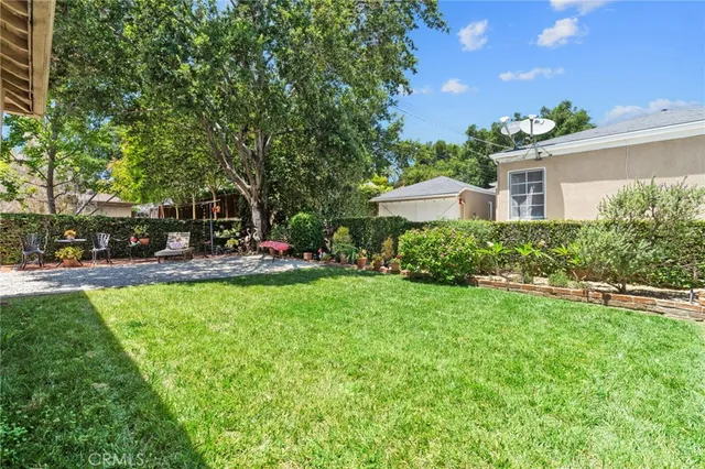 a view of a house with a yard and sitting area